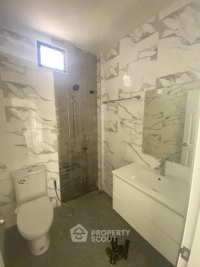Modern bathroom with marble tiles and sleek fixtures