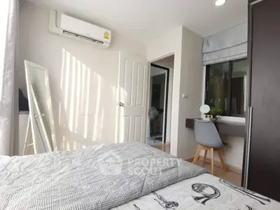 Cozy bedroom with modern decor and natural light, featuring a stylish vanity and air conditioning.