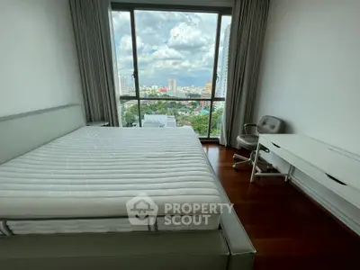 Spacious bedroom with stunning city view and modern furnishings