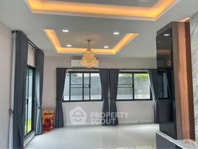 Spacious modern living room with elegant chandelier and large windows