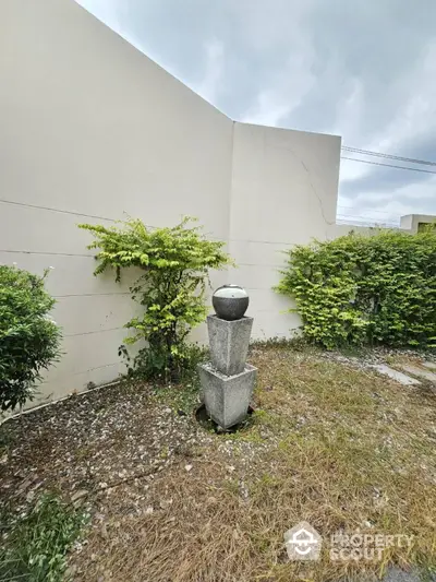 Charming garden corner with lush greenery and decorative stone feature