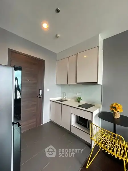 Modern kitchen with sleek cabinets and stylish decor in a contemporary apartment.