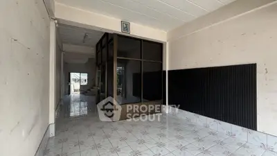 Spacious interior with tiled flooring and partitioned area, ideal for customization.