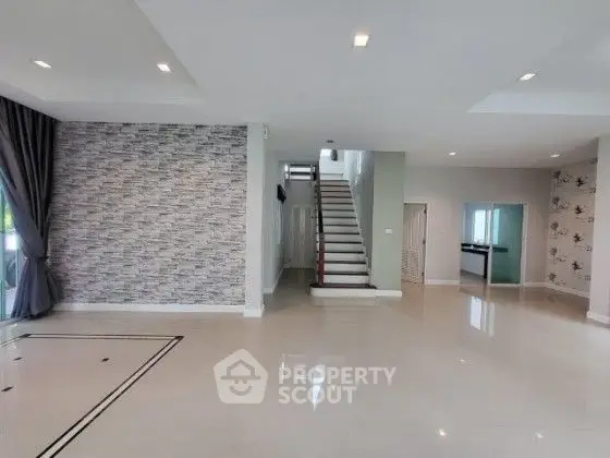 Spacious modern living room with elegant staircase and stylish decor
