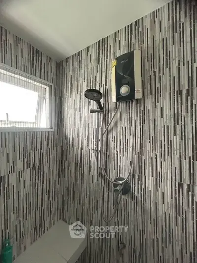 Modern bathroom with stylish tile design and shower unit