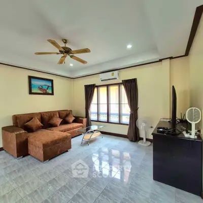 Spacious living room with brown sectional sofa and modern decor