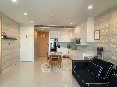 Modern open-layout kitchen and living area with sleek design and stylish furniture.