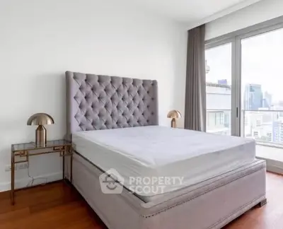 Luxurious bedroom with elegant tufted bed and city view, perfect for urban living.