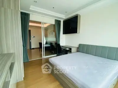 Modern bedroom with sleek design and large window, featuring a comfortable bed and stylish decor.