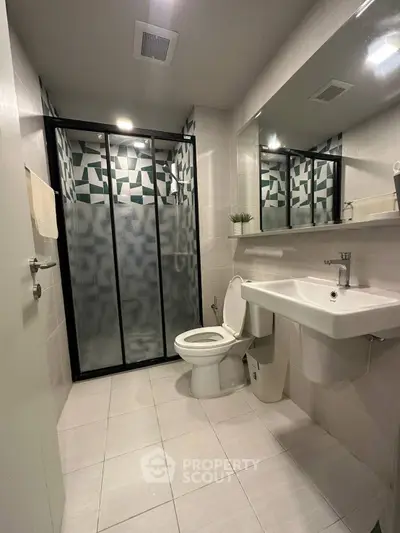 Modern bathroom with geometric shower design and sleek fixtures