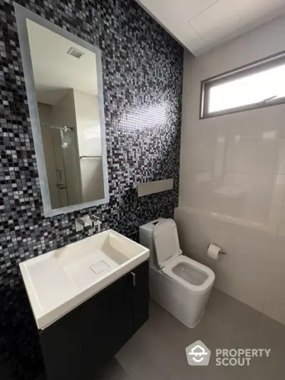 Modern bathroom with sleek design and mosaic tile wall