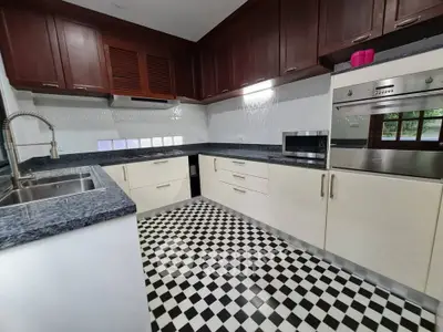 Modern kitchen with checkered floor, dark wood cabinets, and built-in oven