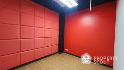 Modern interior room with vibrant red walls and wooden flooring