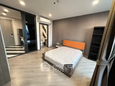 Modern bedroom with ensuite bathroom and air conditioning in stylish apartment