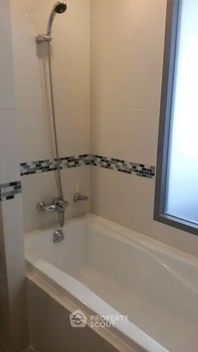 Modern bathroom with sleek bathtub and stylish tile accents