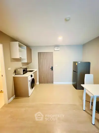 Modern apartment interior with kitchen appliances and dining area