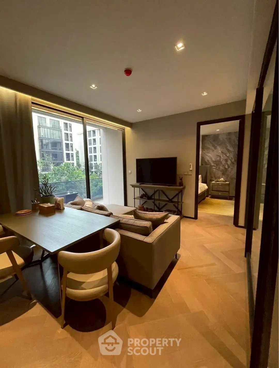 Modern living room with elegant dining area and large window view in luxury apartment.