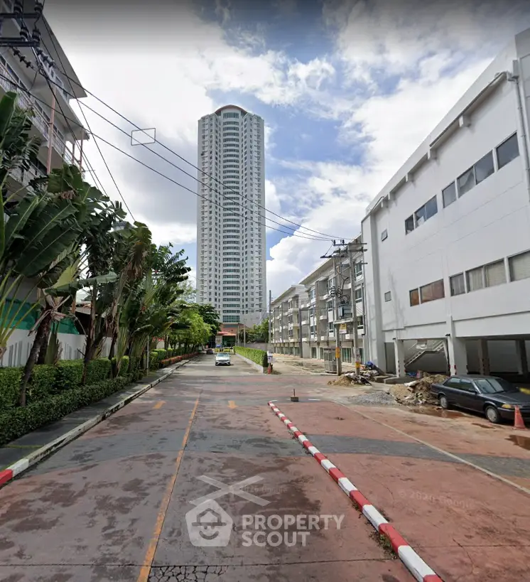 Stunning high-rise building with lush greenery and clear sky view, perfect for urban living.