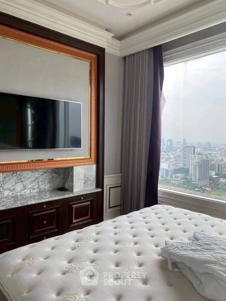 Luxurious bedroom with city view, elegant decor, and mounted TV