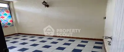 Spacious room with tiled floor and colorful window accents, ideal for creative interior design.