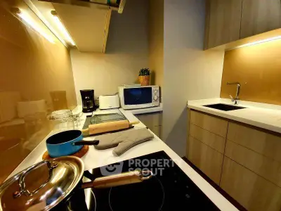 Modern kitchen with sleek appliances and stylish cabinetry, perfect for culinary enthusiasts.