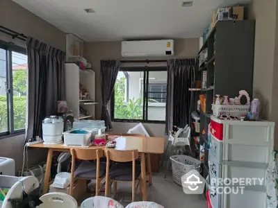 Cozy and cluttered dining area with air conditioning and garden view