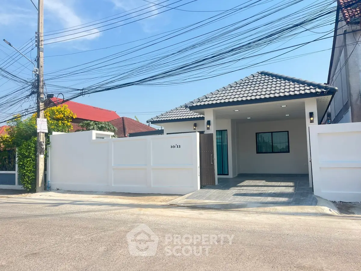 Charming single-story home with modern design and spacious driveway in a serene neighborhood.