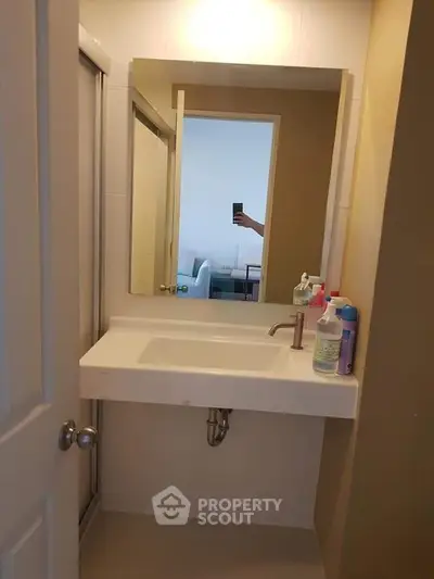 Compact bathroom with modern sink and mirror, ideal for small spaces.