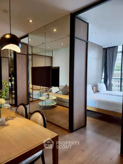Modern apartment interior with open living and dining area, featuring stylish decor and natural light.