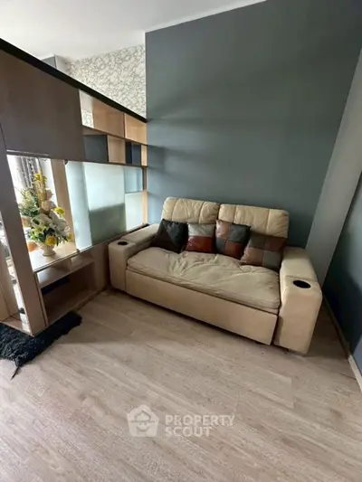 Modern living room with stylish sofa and wooden shelving unit, perfect for cozy relaxation.
