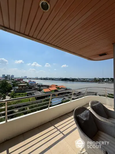 Stunning balcony view overlooking a serene river and cityscape, perfect for relaxation and enjoying sunsets.