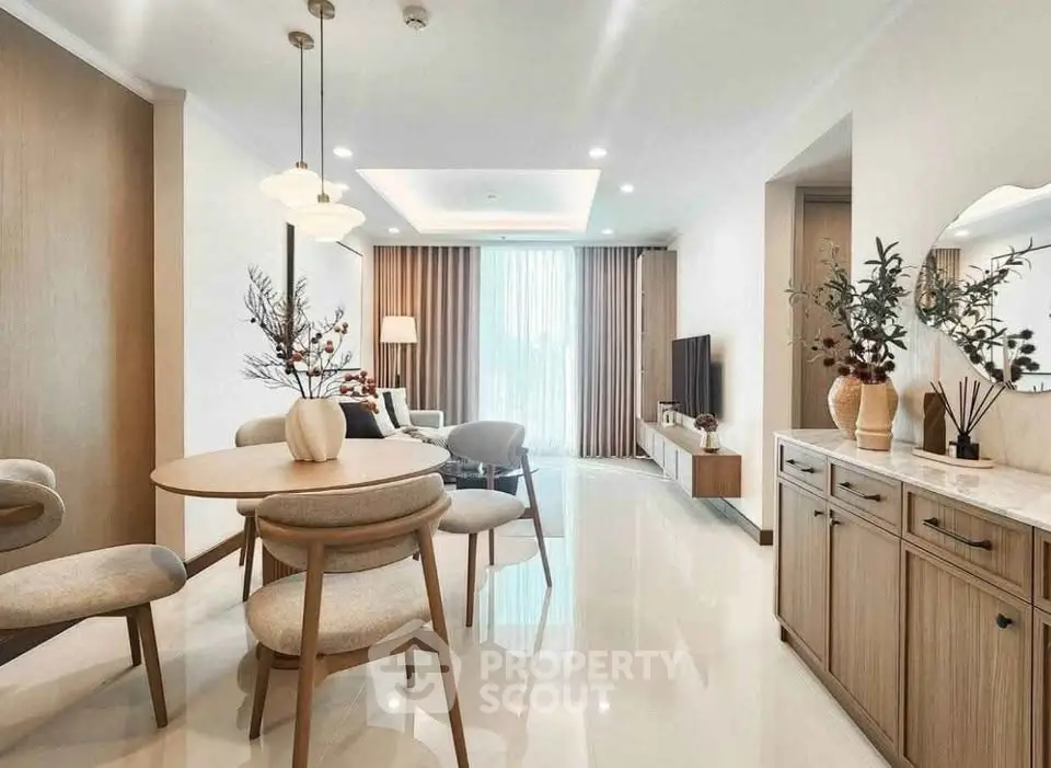 Elegant open-plan living and dining area with modern decor and natural light.