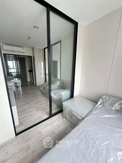 Modern bedroom with sliding glass doors and sleek interior design