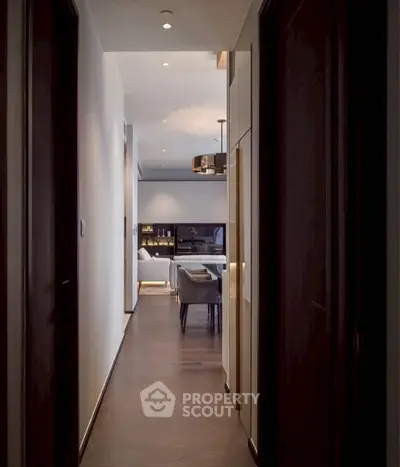 Elegant hallway leading to a modern living room with stylish decor and ambient lighting.