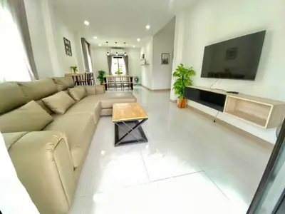 Spacious modern living room with sleek furniture and large TV