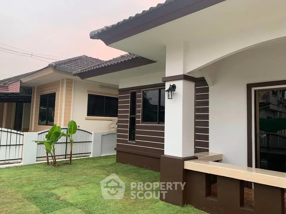 Charming suburban home with modern exterior and lush green lawn, perfect for family living.