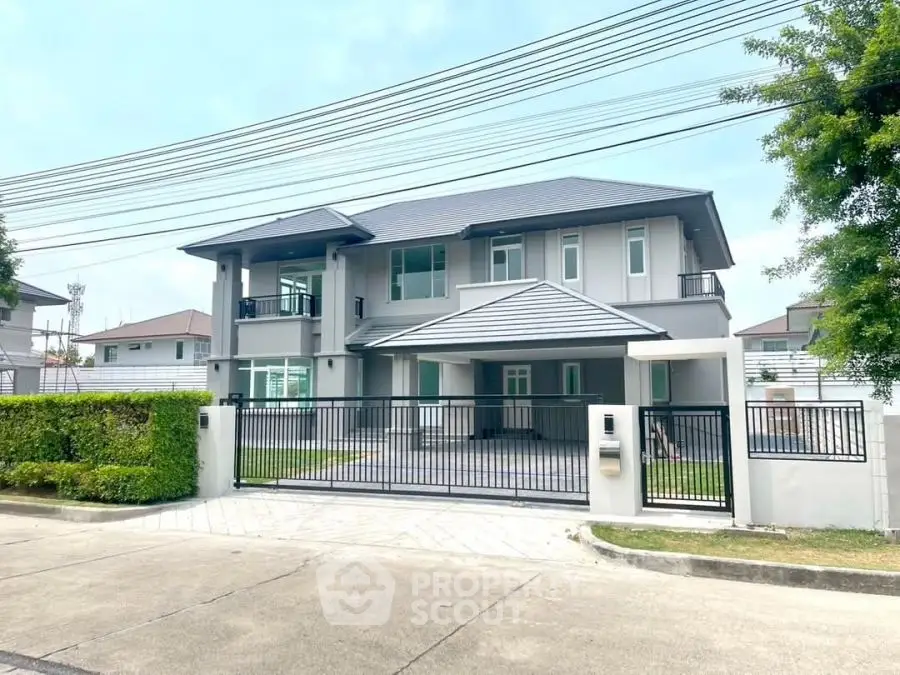 Modern two-story house with gated entrance and spacious driveway