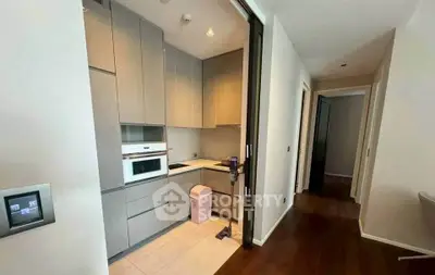 Modern compact kitchen with sleek cabinetry and built-in appliances