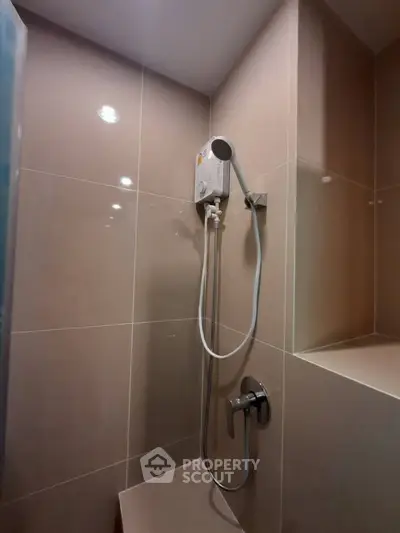 Modern bathroom with sleek shower design and neutral tiles