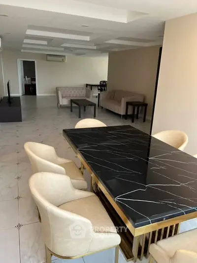 Spacious modern living room with elegant dining area and marble table