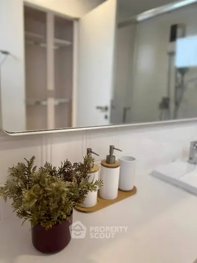 Modern bathroom with sleek countertop and stylish decor accents