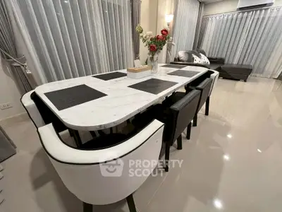 Elegant dining area with marble table and modern decor in a stylish living room