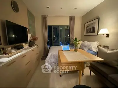 Cozy studio apartment with modern decor and city view, featuring a compact living area and bedroom.