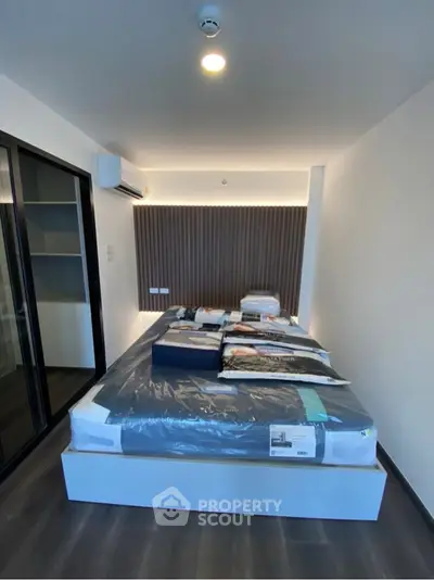 Modern bedroom with sleek design and ambient lighting, featuring a comfortable bed and stylish decor.