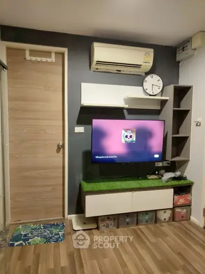 Modern living room with wall-mounted TV and air conditioning