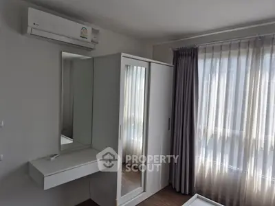 Modern bedroom with sleek wardrobe and air conditioning unit