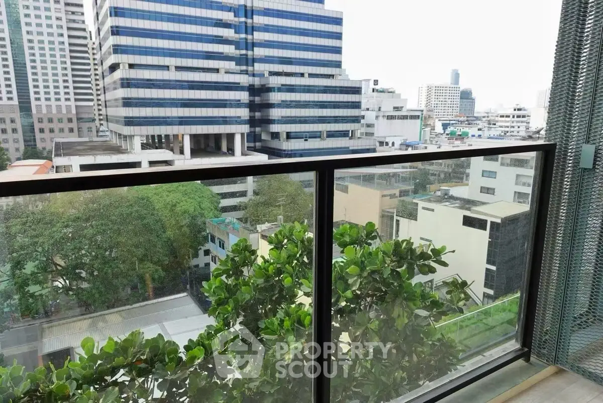 Stunning cityscape view from a modern balcony with lush greenery, perfect for urban living.