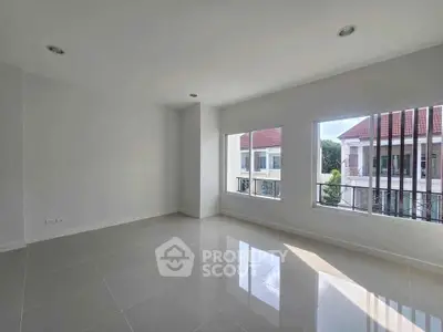 Bright empty room with large windows and glossy tiled floor