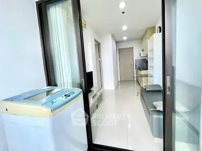 Modern apartment interior with washing machine and sleek furnishings