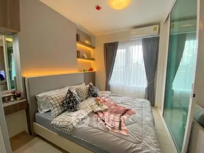 Cozy modern bedroom with stylish decor and ample natural light